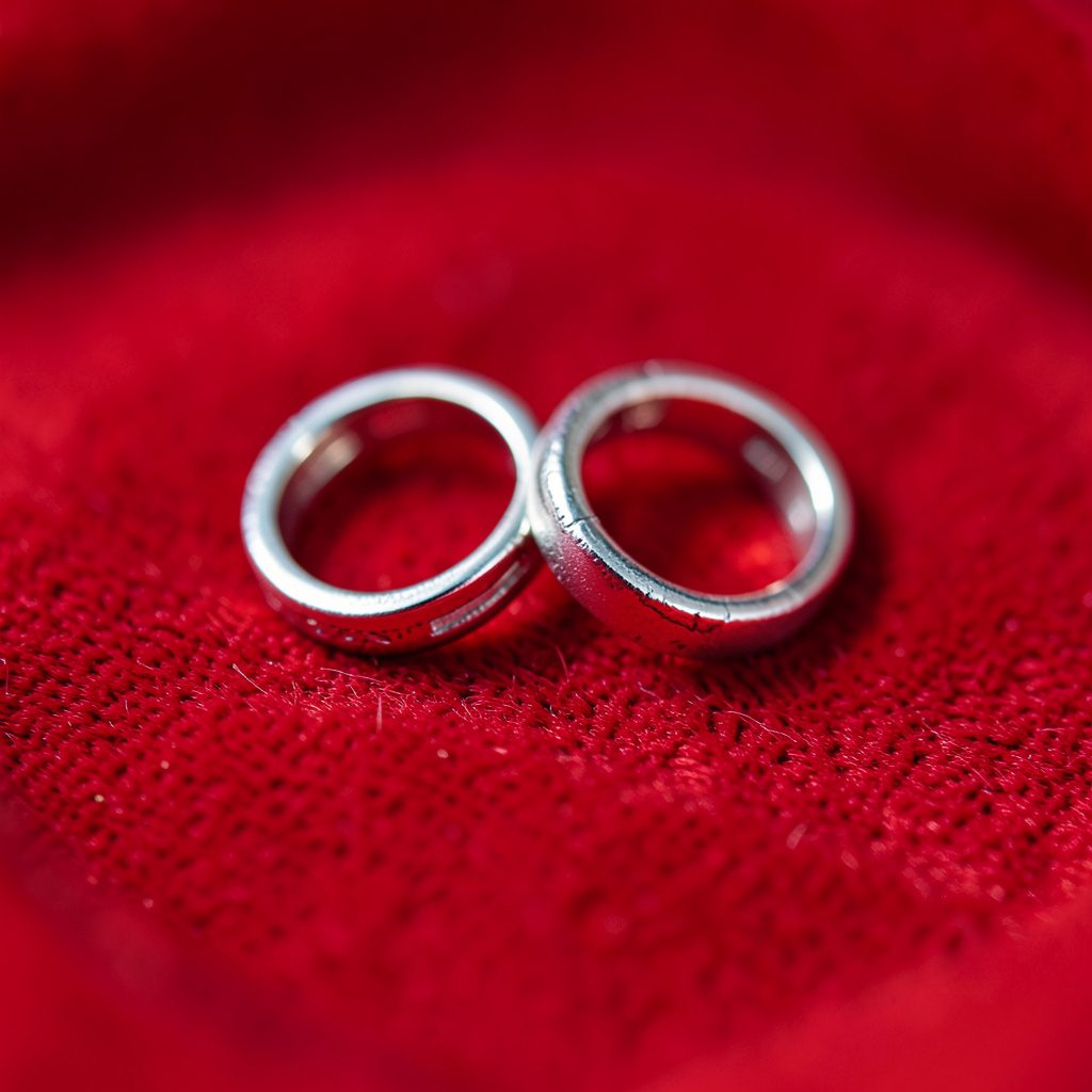 Elegant bridal drop earrings with a pearl and crystal design, photographed close-up on a neutral surface.